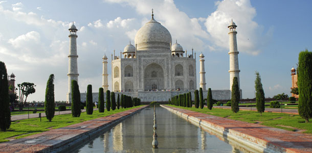 The Taj Mahal with white domes and reflection in water