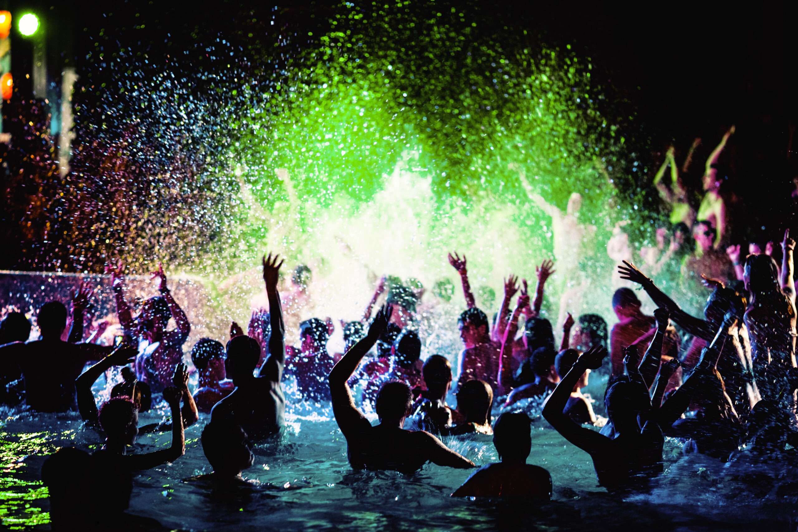 Night party of people in the pool.