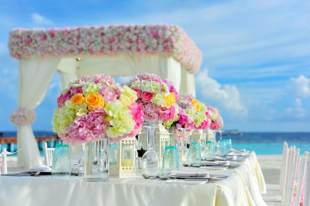 Beachfront destination wedding setup with vibrant flowers, symbolizing Indian wedding traditions